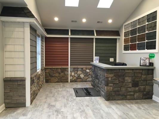 The Interior of our showroom displaying roofing, siding, and stone work.