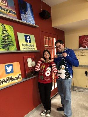 Edwin P. and I modeling ugly Christmas sweaters for a contest at the location.