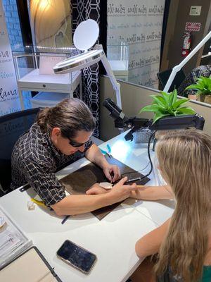 Permanent Jewelry being done on a girls wrist at the Elisa Ilana Jewelry Store