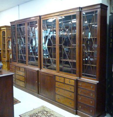 A period English Regency wall unit, or library. It is 13' wide and stands 8'6" high. Comes in 8 parts, can be moved.