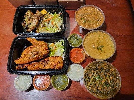 Original and Cilantro Tikka, Chana Saag, Dal Makhani, and Fish Korma with additional condiments