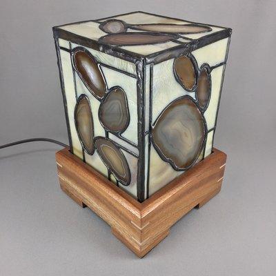 We have an exclusive line of stained glass and agate lamps made here in the studio. This is one of the lamps when it is turned off.