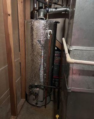 Replaced a 15-year-old water heater with a new Rheem water heater, backed by a 9-year warranty.