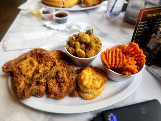 Lunch fried Pork Chop with fried okra, and sweet potato waffle fries