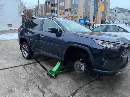 Car was jacked up so tire could be removed for repair.