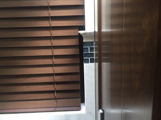 Horizontal wood blind we installed with a special notch for the tile.