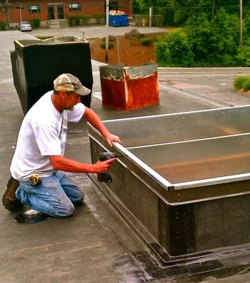 Installing a curb for an HVAC unit.