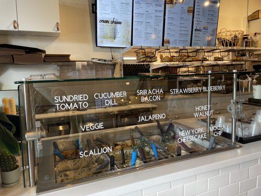 Counter with the cream cheese options on glass