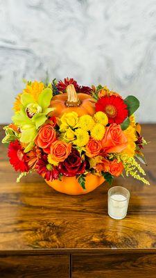 Beautiful fall arrangement in the pumpkin container