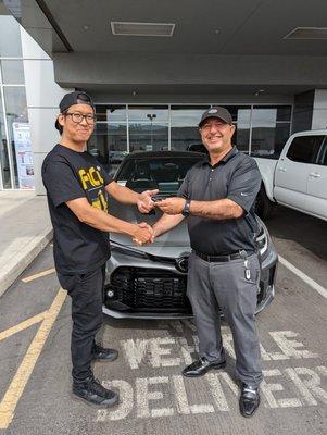 Mohamed handing me the keys to my new Corolla