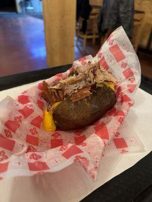 Stuffed baked potato with pulled pork, bacon, butter, sour cream, cheese. It was excellent.