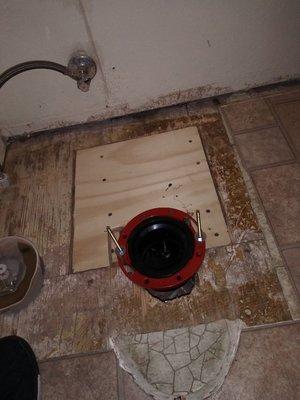 New flange for sewer line and replace section of floor for restroom