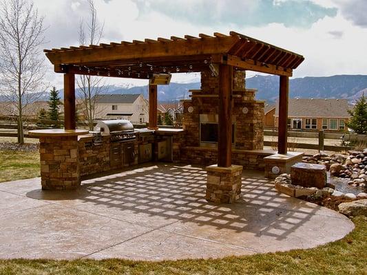 outdoor kitchen with pergola and water feature