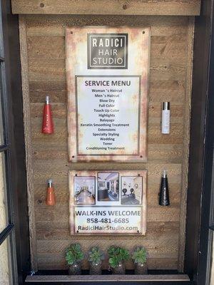 Charming display case features the salon services outside the salon.