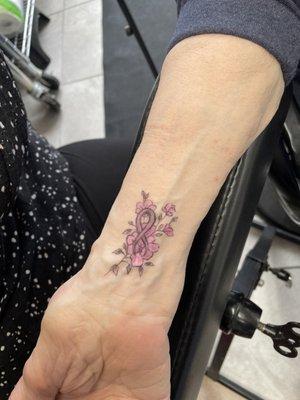 My grandma's tattoo- flowers and a breast cancer ribbon.