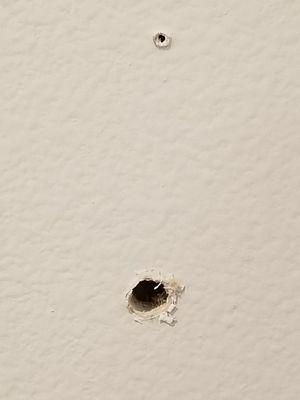 The damage to my wall left by ADT. Drilled all the way through from my entry into my garage.