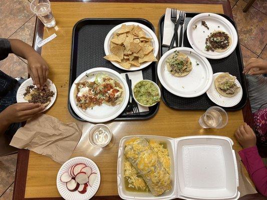 Wet burrito, carnitas tacos, pollo tacos, pescado tacos, guacamole, and chips