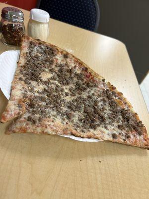 Cheese pizza with ground beef toppings