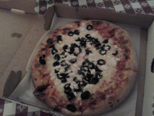 A small pizza with black olives and feta cheese