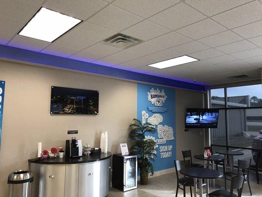 Lobby with coffee, water, and tv's.