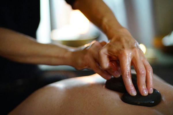 Arnica oil & hot stones provide penetrating heat for tired and aching muscles in our Arnica and Comfry Massage.