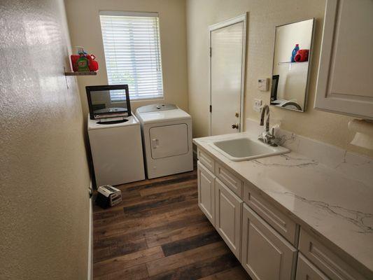 Laundry room floors, cabinets and drywall.