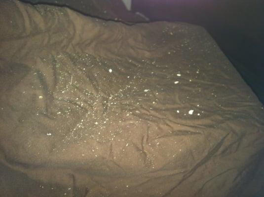 My bed sheets, covered in dust and pebbles from the ceiling and walls above