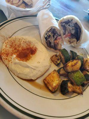 Gyro sandwich with hummus, grilled zucchini and fresh warm pita.