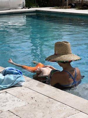 Emily helping my boy learn to put his ears under water.