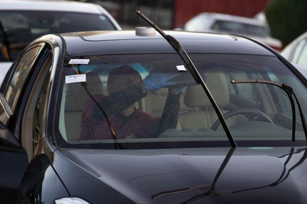 Reattaching the rearview mirror, after windshield installation.