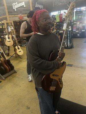 My Princess shopping for a Jazz Bass Guitar with our favorite sales associate Ben. (Not the guy photobombing )