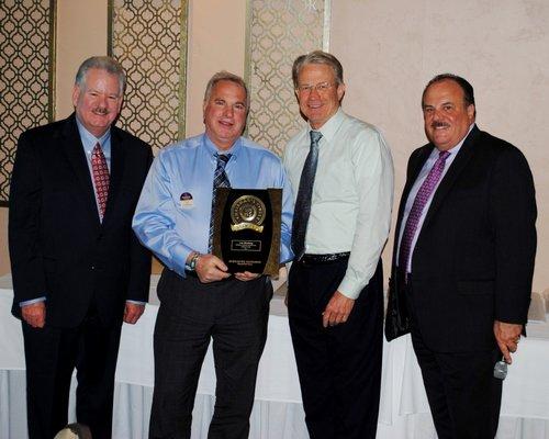 Lee receivning to listing agent and top transactions for 2018. Award presented by Owner/Broker Brian Boisson, John Gieseker & Larry Franzell