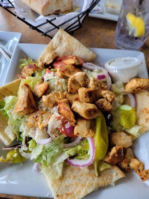 Chicken souvlaki salad with pita.