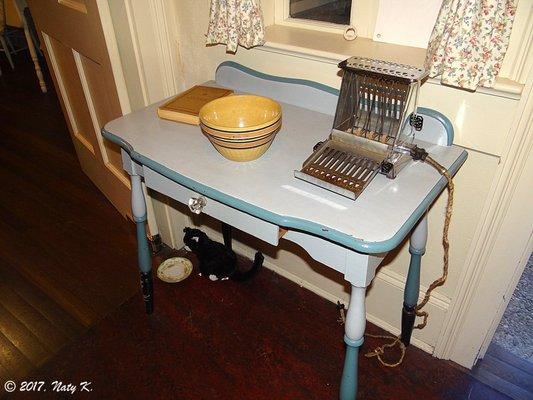 The kitchen area, and a toaster on the counter.