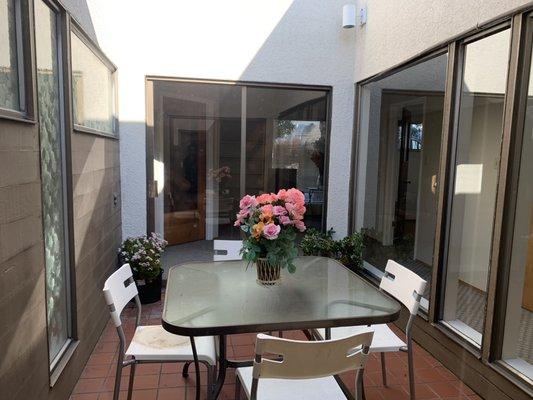 Cozy patio where guest could enjoy the sun with a green tea.