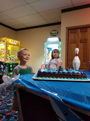 He was so excited when he saw the cake and the bowling Pin for his friends to sign.