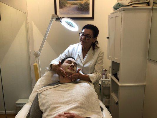 Donna performing a cleansing facial at Split Enz Salon & Spa. She also does peels and other skin care services.