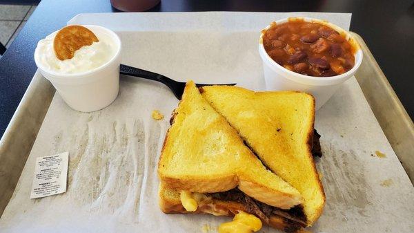 Brisket Mac sandwich meal with baked beans and banana pudding