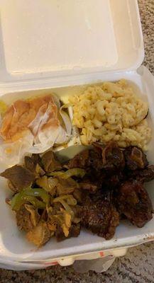 Combo meal.... curry goat, oxtail, corn pudding and Mac & cheese