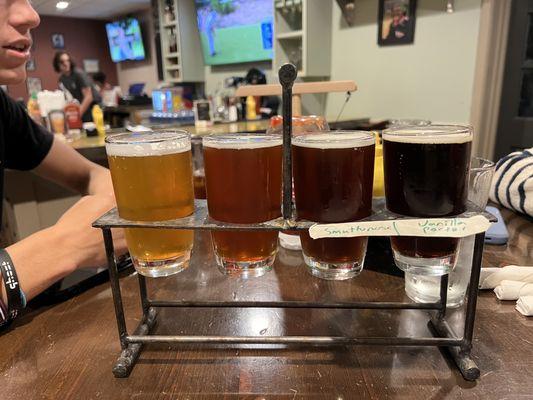 Impressive sized flight of beers.