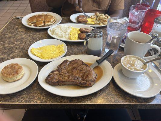 T one, scrambled eggs, grits, biscuit, and coffee