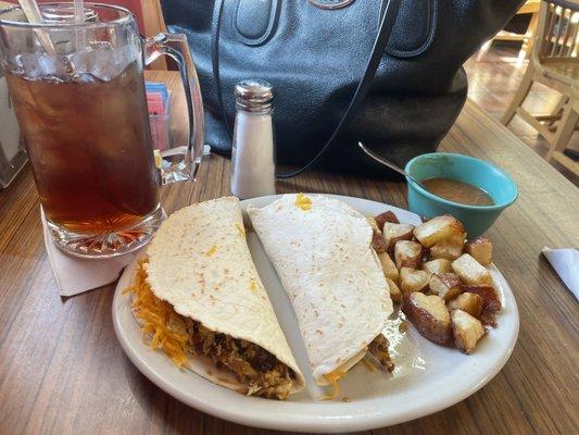 Two huge bacon, egg, and cheese tacos, a side of potatoes, and a giant ice tea!