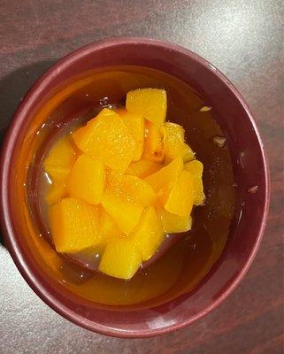 Serving of chipped canned peaches.