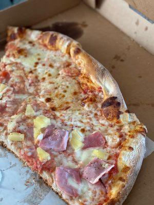 Large cheese pizza with two Hawaiian slices