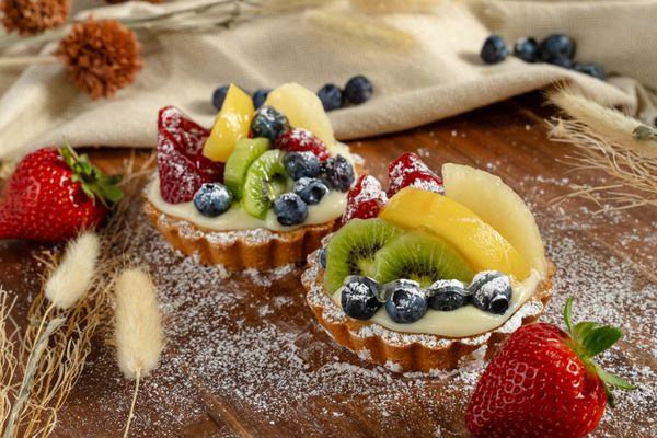 A buttery crust, creamy custard, and fresh kiwi, berries, and peach, dusted with sugar--this fruit tart is an irresistible treat!