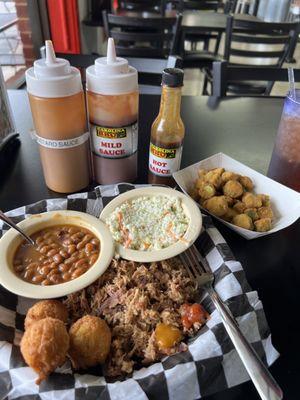 Tuesday special: pullee BBQ Pork, baked beans, coleslaw, and hush puppies. I added a side of fried okra. Sauces are also shown.