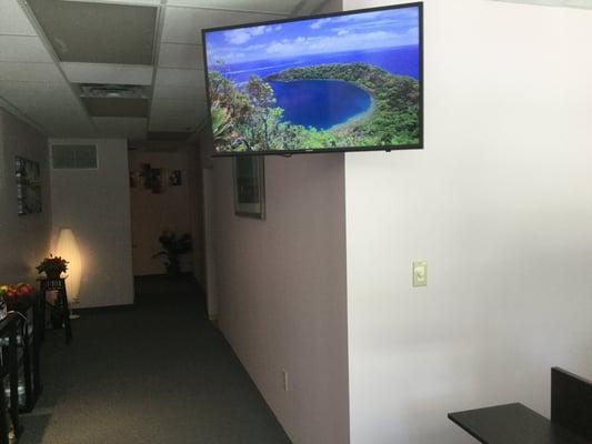 Relaxing reception area with streaming video and music to relax you, even before your massage therapy begins