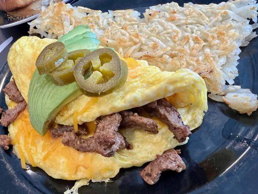 Carne Asada $11.99
 carne asada and grilled onions, topped with avocado & jalapeños, and cheese servedw ith has browns and toast