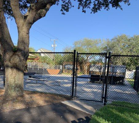 Fenced in skate park area.