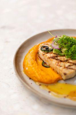 Grilled Pacific Swordfish: roasted carrot puree, persian cucumber and avocado
 salad, passionfruit butter, fresh herbs